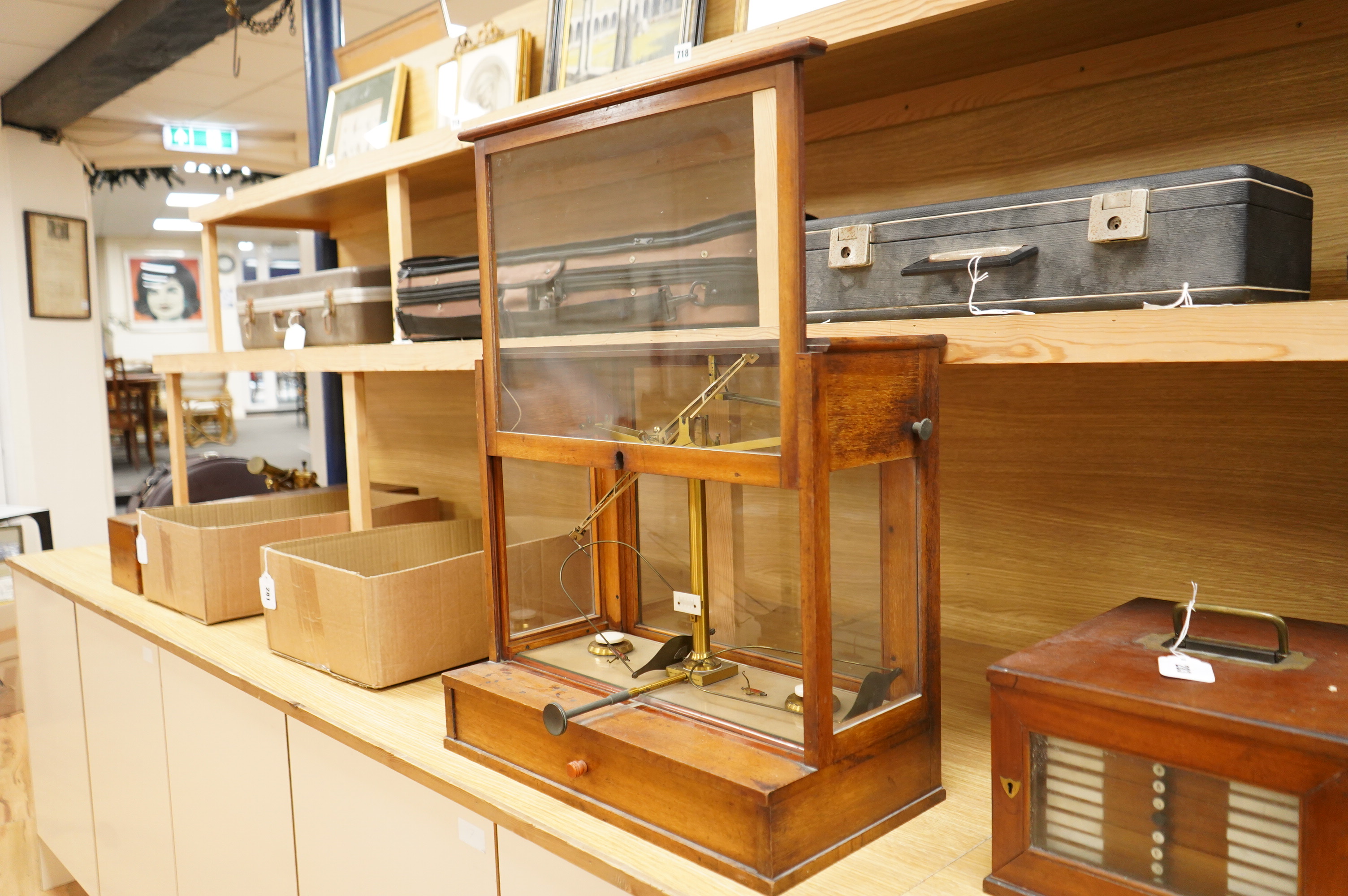 An early 20th century glazed mahogany cased laboratory chemical balance by Oertling, London, the drawer housing a set of weights, 45.5cm high, 50cm wide, 26cm deep